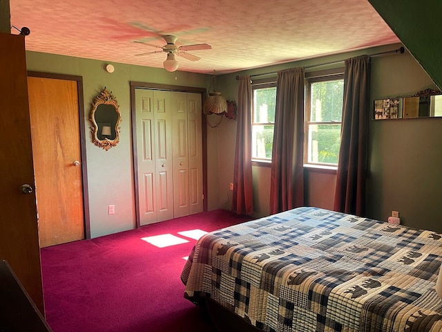 carpeted bedroom with ceiling fan, a textured ceiling, and a closet