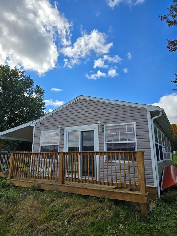 back of house featuring a deck