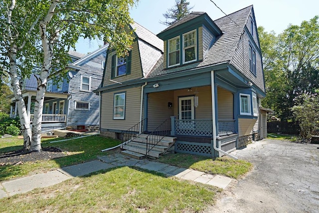 view of front of home featuring covered porch and a front lawn