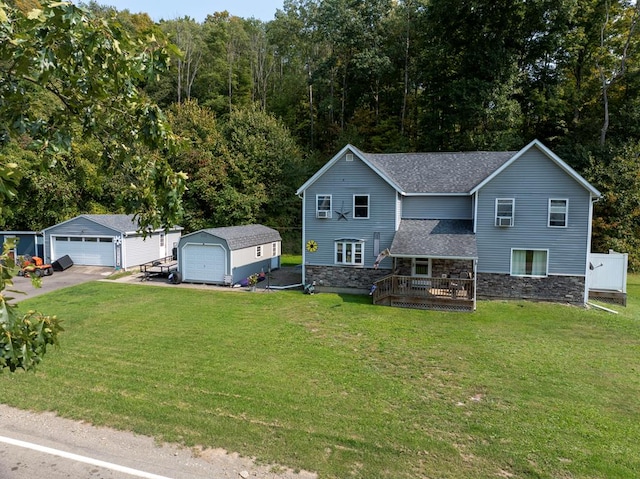 view of front facade featuring a garage, an outdoor structure, a front yard, and covered porch