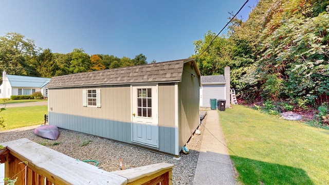 view of outbuilding featuring a lawn