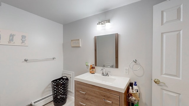 bathroom with a baseboard radiator, vanity, and toilet