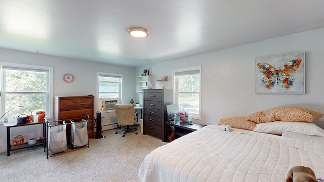 bedroom with multiple windows, cooling unit, light colored carpet, and baseboard heating