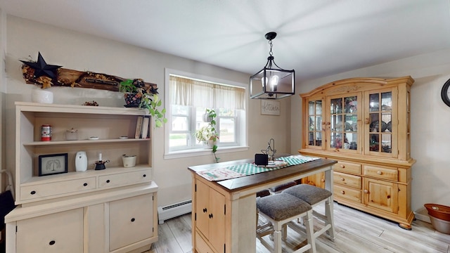 office area with light wood-type flooring, a chandelier, and baseboard heating