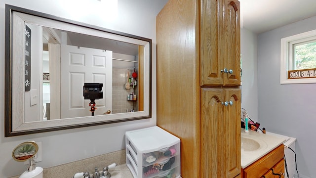 bathroom featuring walk in shower and vanity