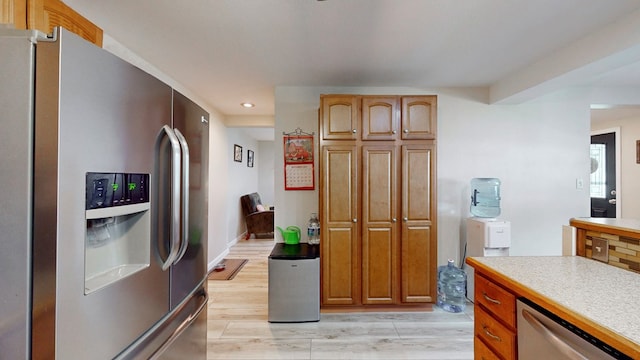 kitchen with stainless steel appliances and light wood-type flooring