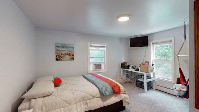 bedroom with multiple windows, cooling unit, light colored carpet, and a baseboard heating unit