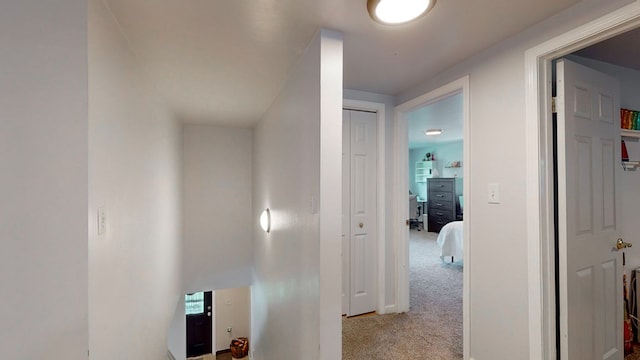 hallway featuring light colored carpet