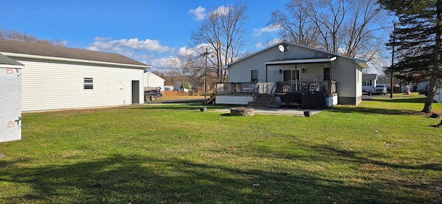 view of yard with a deck and a fire pit