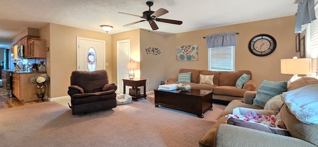 carpeted living room featuring ceiling fan