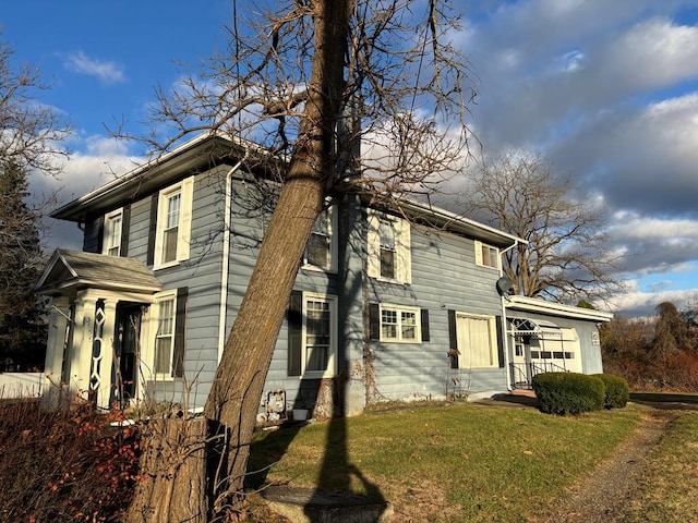 view of side of home featuring a lawn