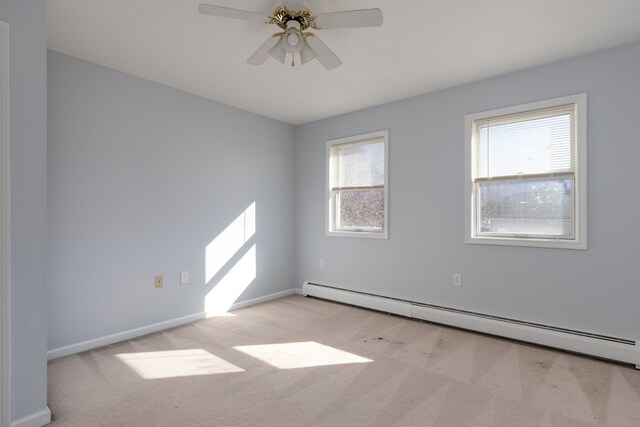 empty room featuring a baseboard radiator, light colored carpet, and ceiling fan