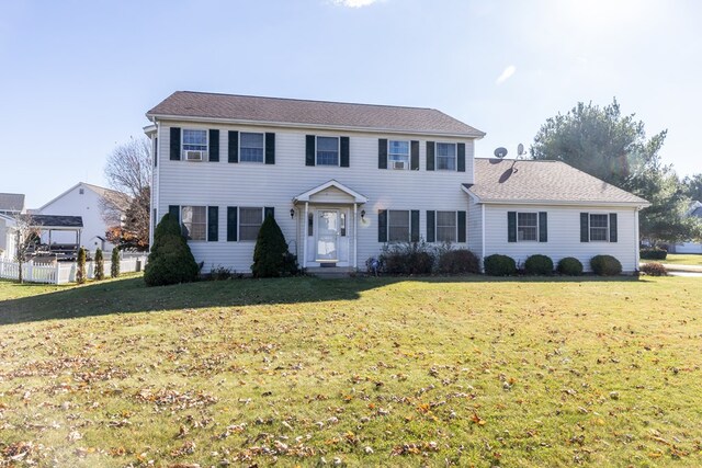 colonial inspired home with a front lawn