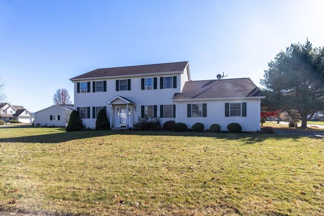 colonial-style house with a front lawn