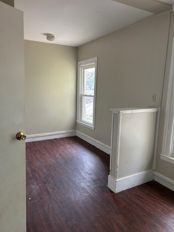 spare room with dark wood-type flooring