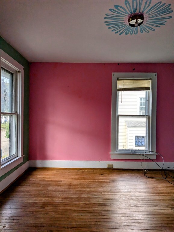 unfurnished room featuring hardwood / wood-style floors