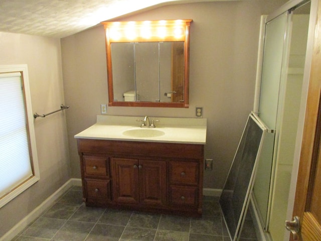 bathroom featuring vanity, vaulted ceiling, an enclosed shower, and toilet