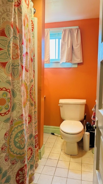 bathroom with toilet and tile patterned flooring