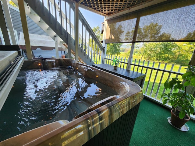 sunroom / solarium featuring a hot tub