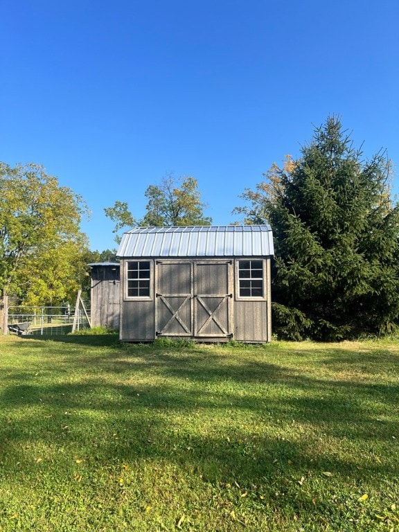 view of outbuilding featuring a lawn