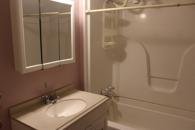 bathroom with washtub / shower combination and vanity