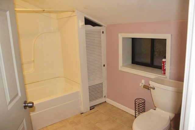 bathroom with tile patterned flooring, shower / bathtub combination, and toilet