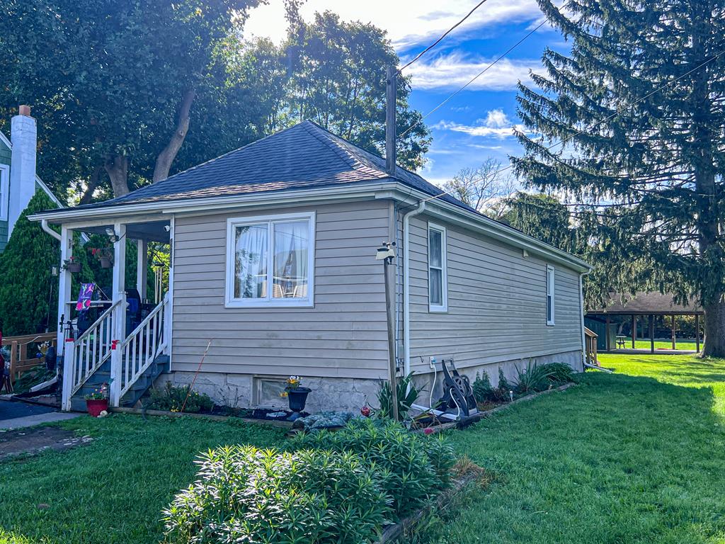 view of property exterior with a lawn