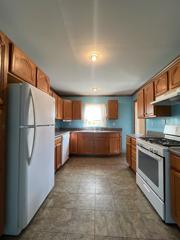 kitchen featuring white appliances and sink