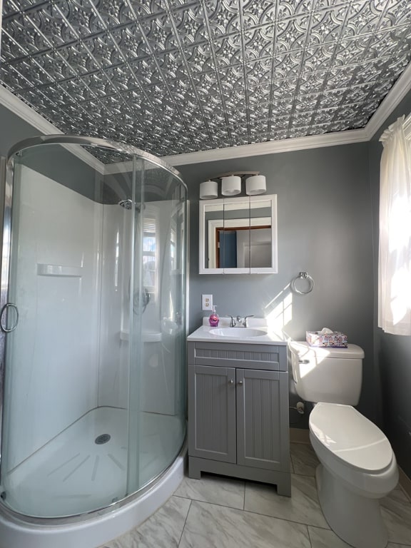 bathroom with ornamental molding, a shower with door, and vanity