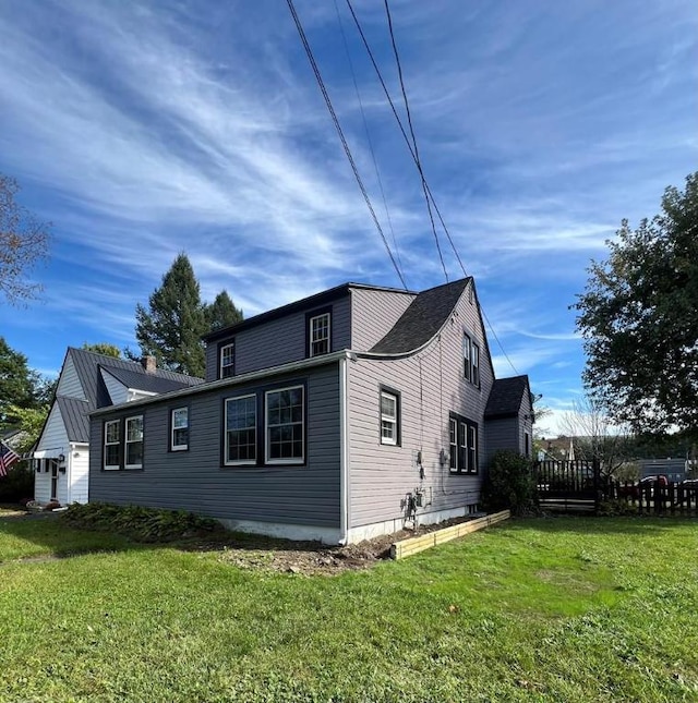 view of side of home with a yard