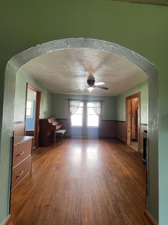 interior space featuring dark wood-type flooring, ceiling fan, and a textured ceiling