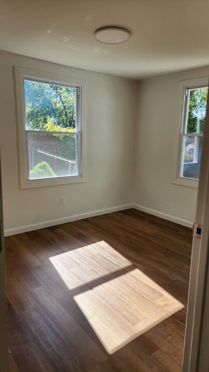 unfurnished room with dark hardwood / wood-style floors