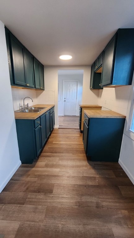 kitchen featuring wooden counters, sink, and light hardwood / wood-style flooring