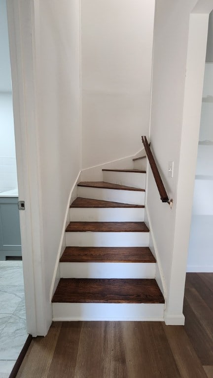 stairway featuring wood-type flooring