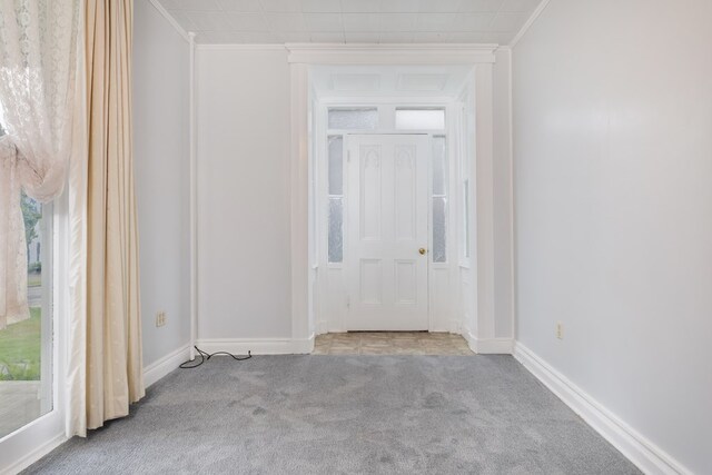 carpeted empty room featuring crown molding and a healthy amount of sunlight