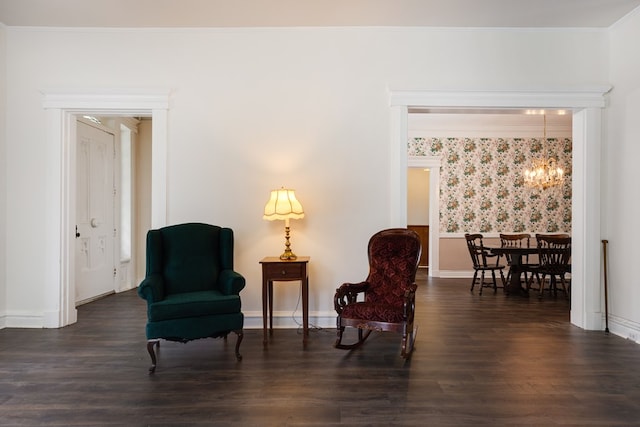 living area featuring ornamental molding, a chandelier, and dark hardwood / wood-style flooring