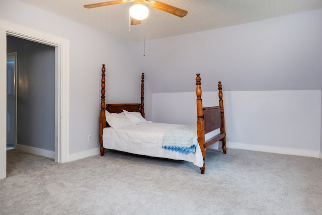 carpeted bedroom with ceiling fan, lofted ceiling, and a textured ceiling