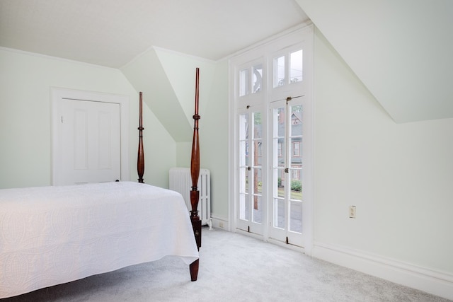 carpeted bedroom featuring lofted ceiling, radiator heating unit, and ornamental molding