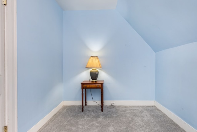 interior space with light colored carpet and lofted ceiling