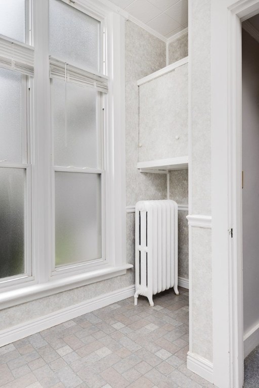 interior details with ornamental molding and radiator heating unit