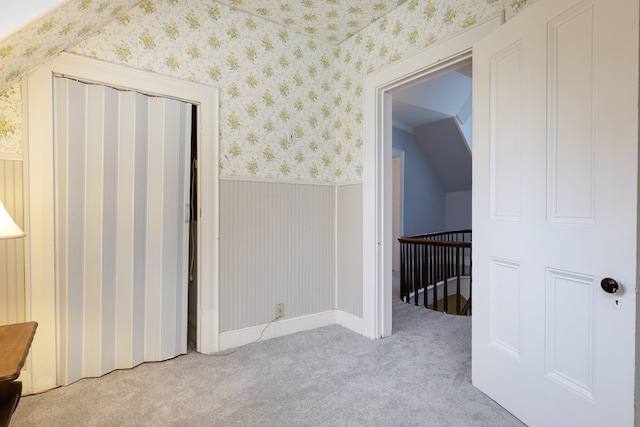 interior space with light carpet and lofted ceiling