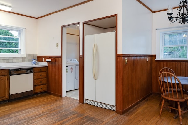 kitchen featuring crown molding, white appliances, plenty of natural light, and washer / dryer