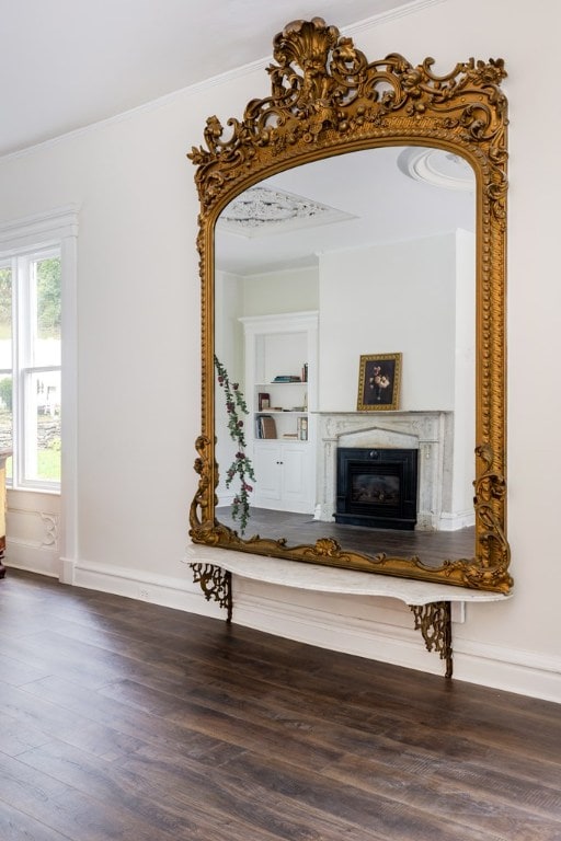 hall with hardwood / wood-style flooring and ornamental molding