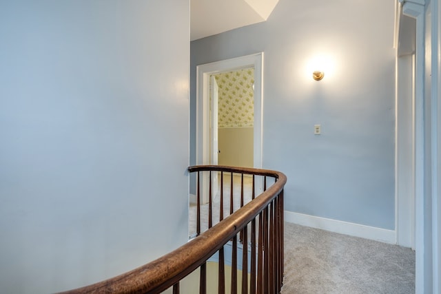 corridor featuring light colored carpet