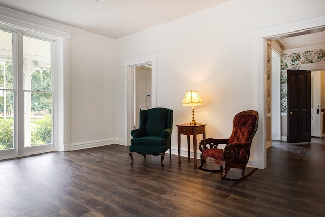 sitting room with crown molding and dark hardwood / wood-style floors