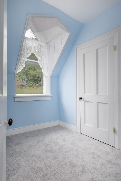 bonus room featuring light colored carpet and lofted ceiling