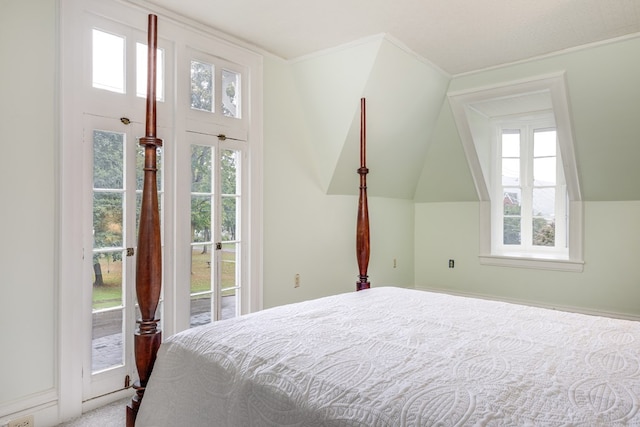 bedroom with access to exterior and vaulted ceiling