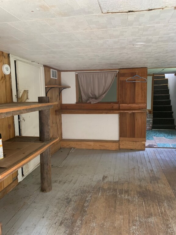 basement with hardwood / wood-style floors