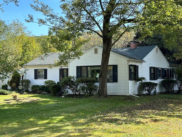 back of property featuring a lawn