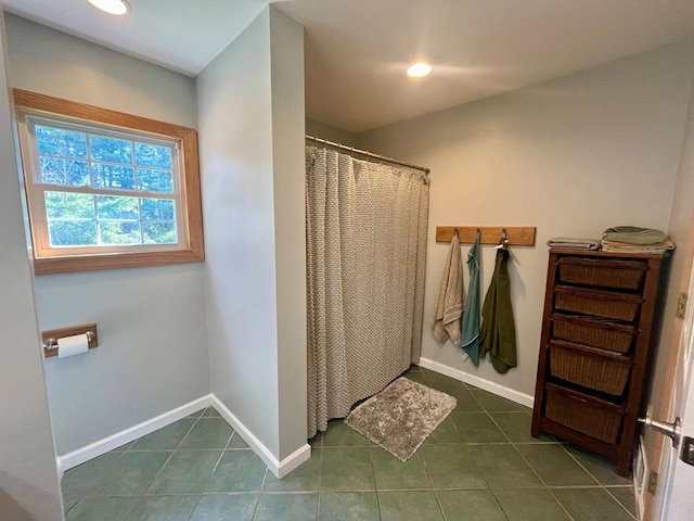 bathroom featuring walk in shower and tile patterned floors